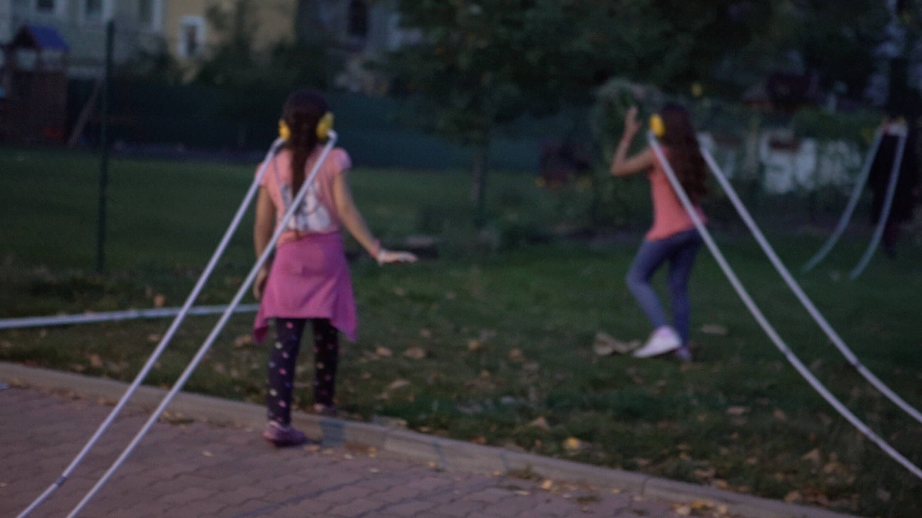 children exploring the grass and concrete