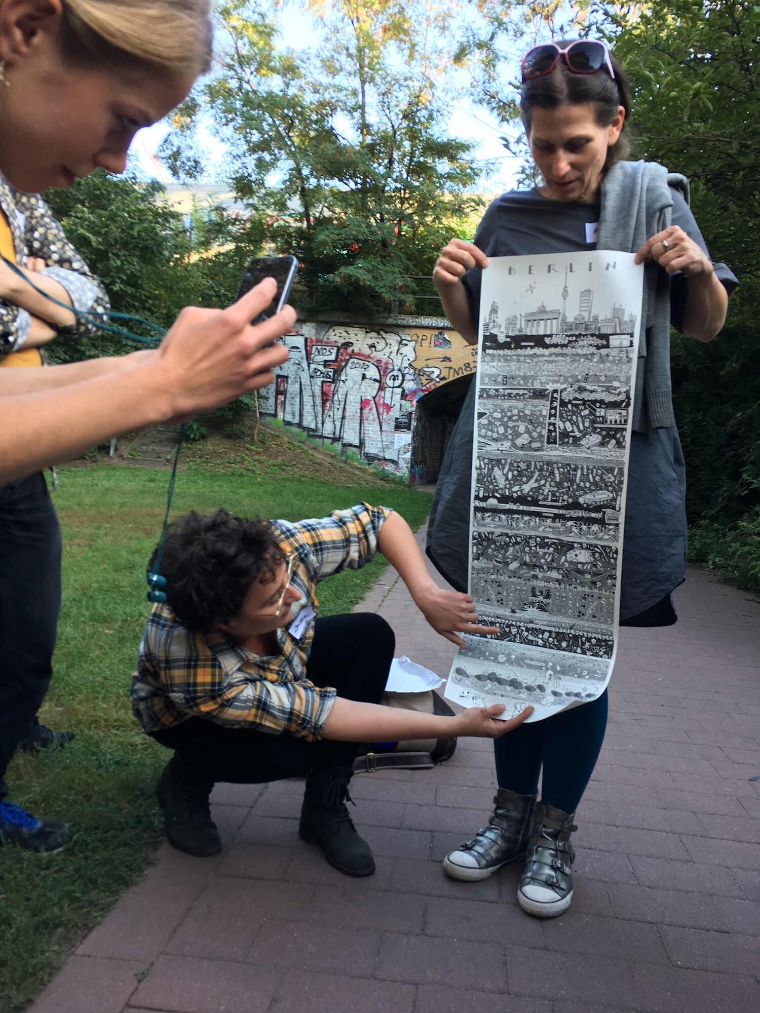 India showing poster about underground layers of Berlin